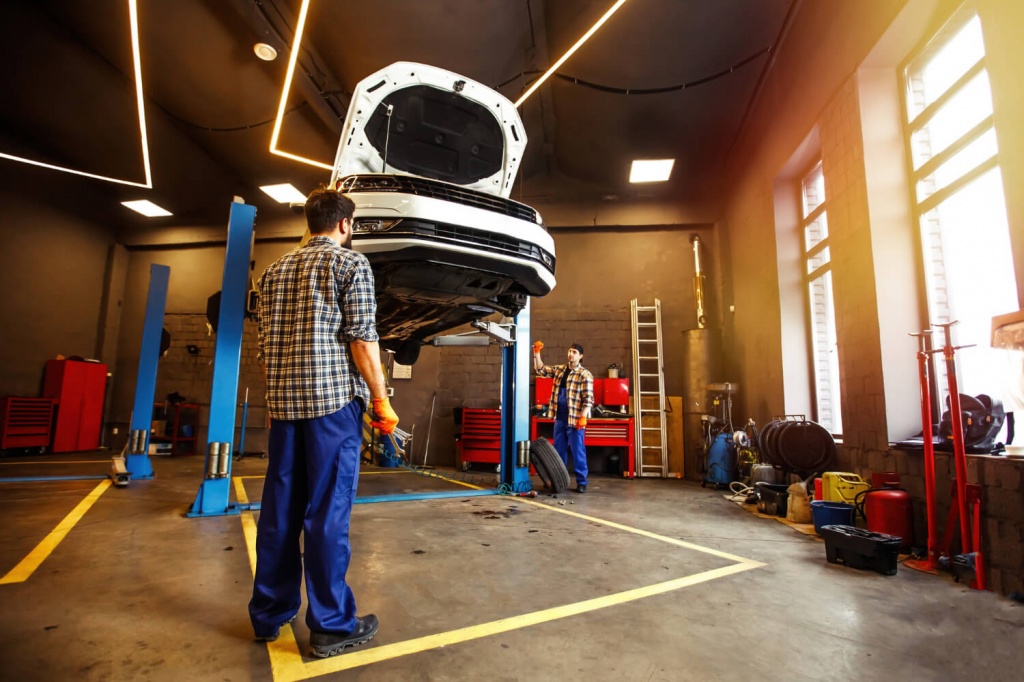 two-specialists-uniform-repairing-car-together-garage.jpg two-specialists-uniform-repairing-car-together-garage.jpg