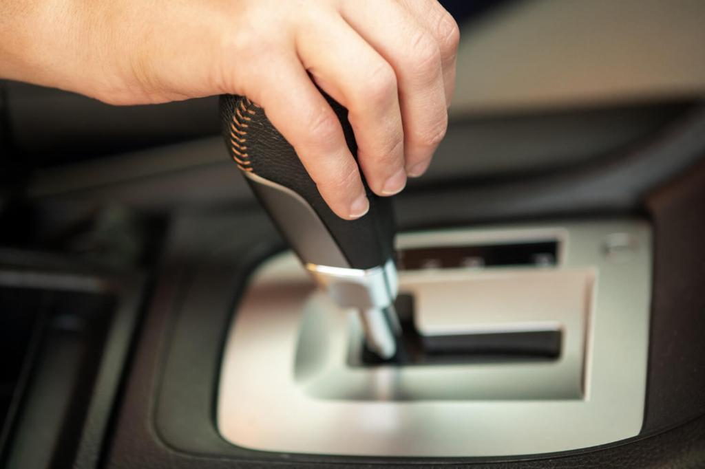 close-up-woman-driver-holding-her-hand-automatic-gear-shift-stick-driving-as-car.jpg