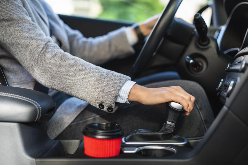 side-view-businesswoman-using-stick-shift-her-car.jpg