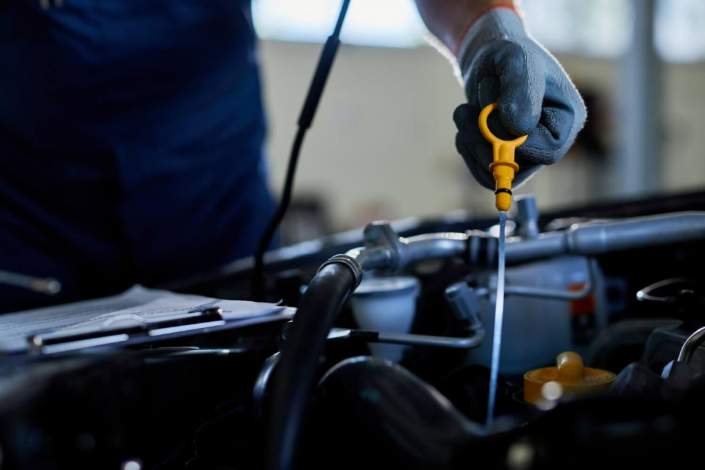 closeup-auto-repairman-checking-car-oil-workshop.jpg